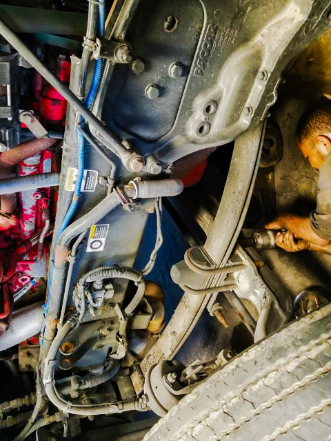 Our mechanic taking off leaf spring by removing u bolts on steering axle from a Kenworth US 281 Truck And Trailer Services LLC Edinburg